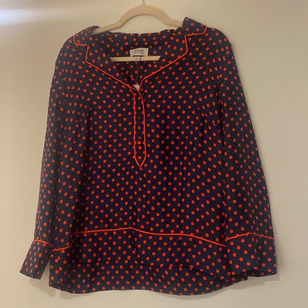 Silk Panama style pullover top. Navy background with red dots. 3 button placket